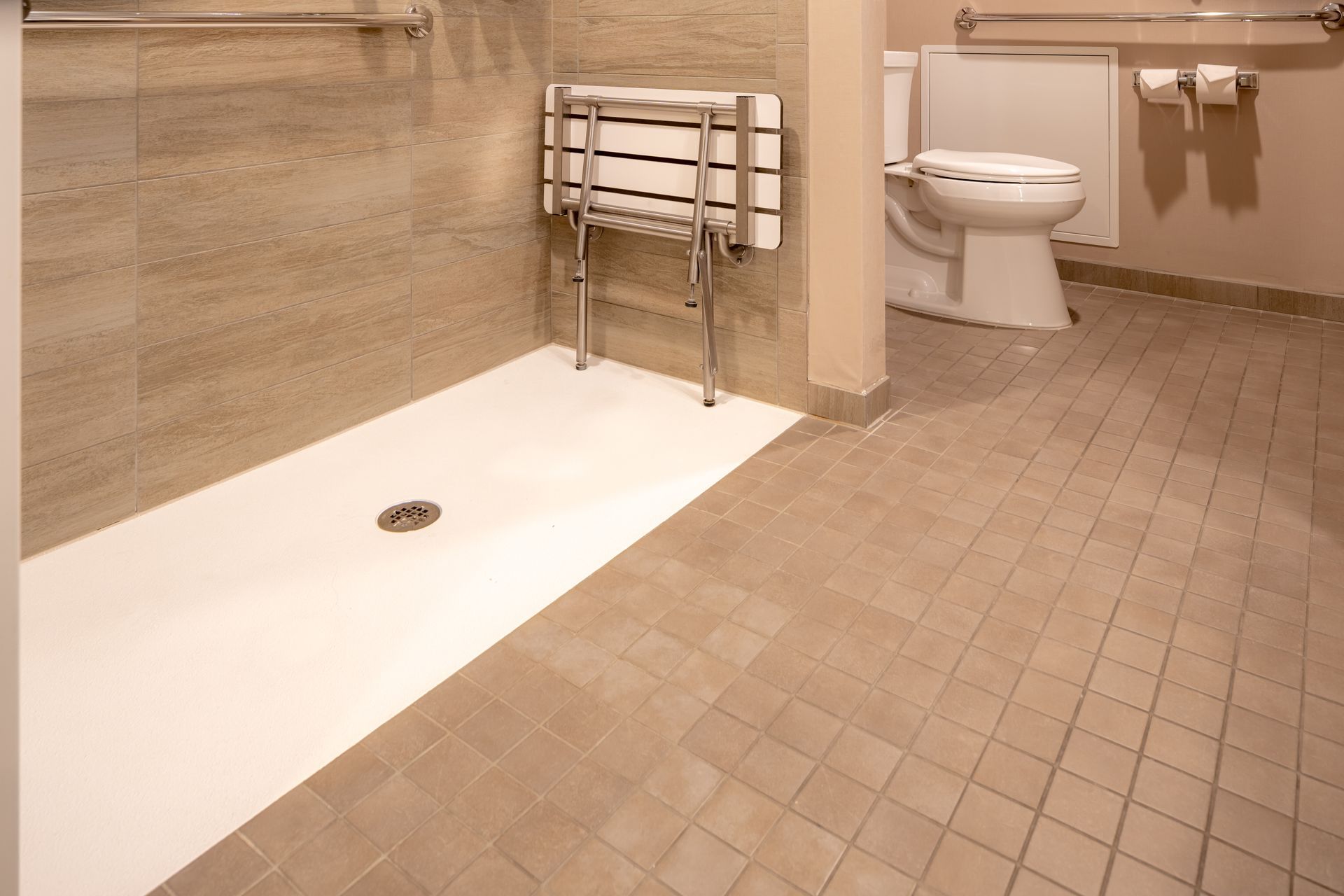 Accessible bathroom with walk-in shower, toilet, and wall-mounted grab bars Accessible bathroom with walk-in shower, toilet, and wall-mounted grab bars