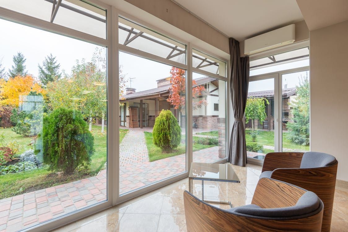 Sunroom with large windows overlooking. Sunroom with large windows overlooking.