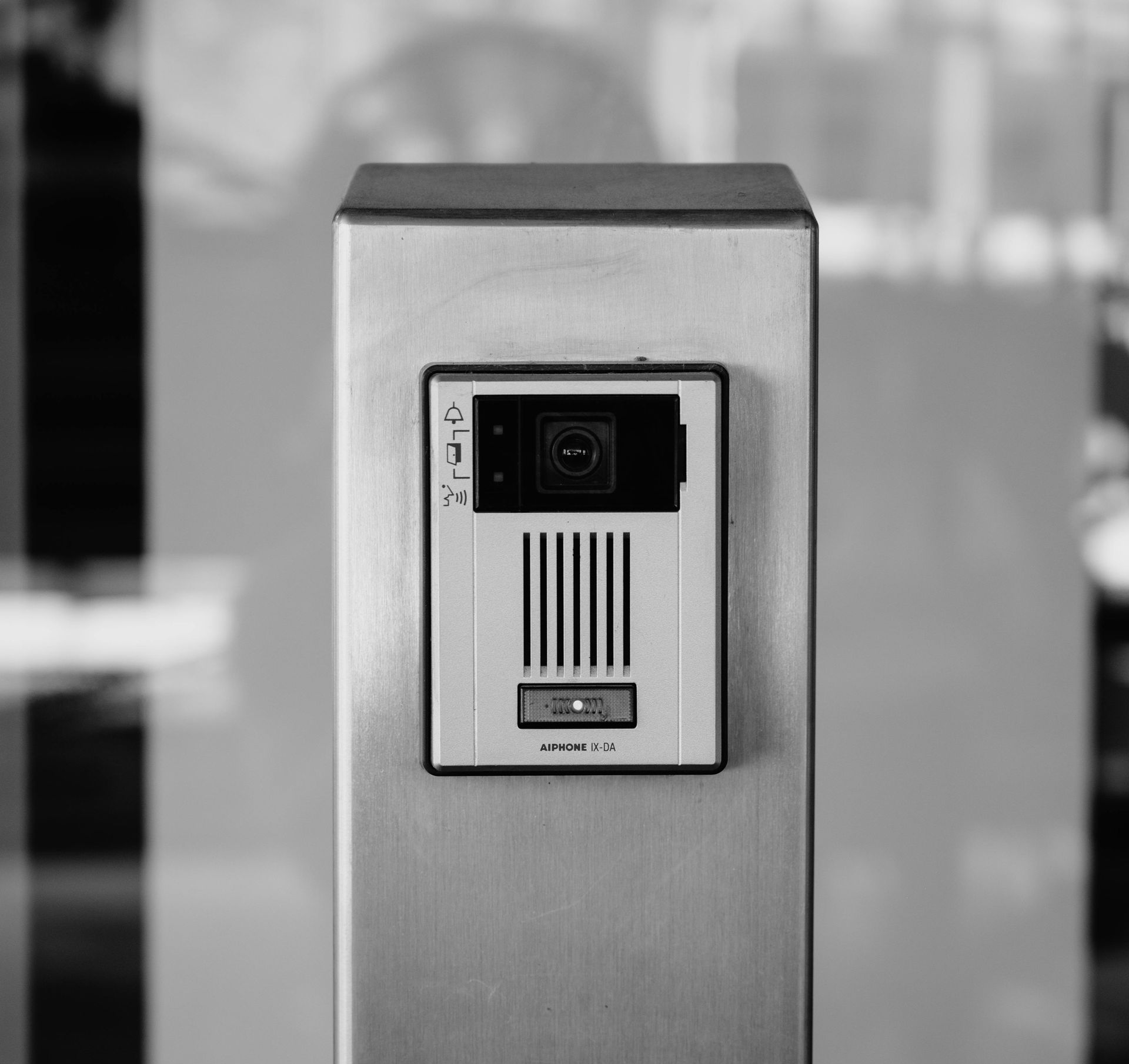 Sistema di interfono con telecamera su palo metallico.