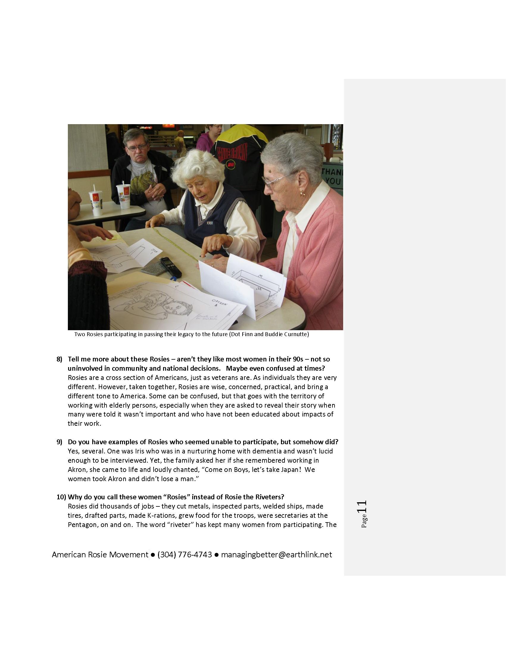 A group of people are sitting at a table looking at papers.