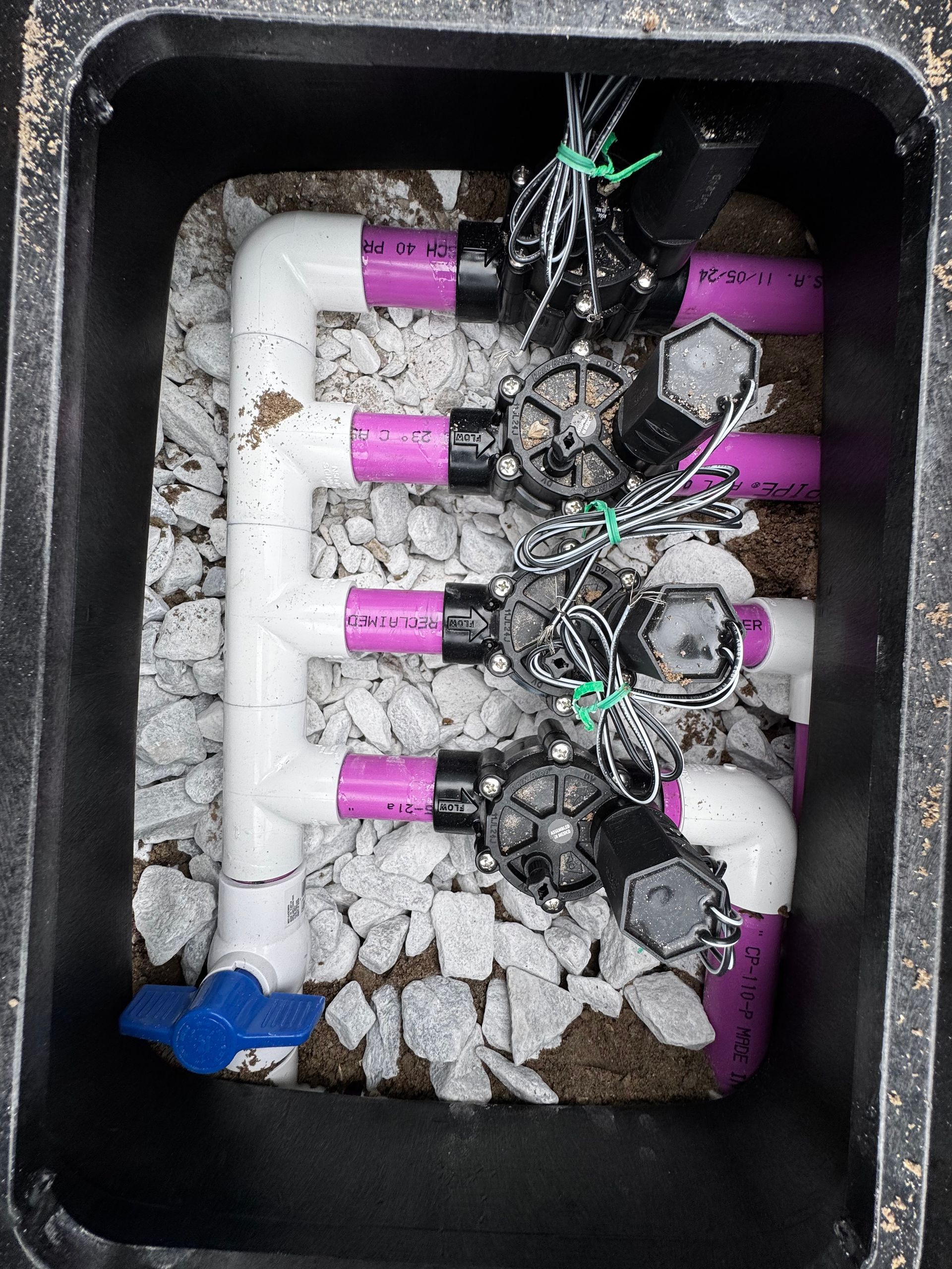 A box filled with purple and white pipes and valves