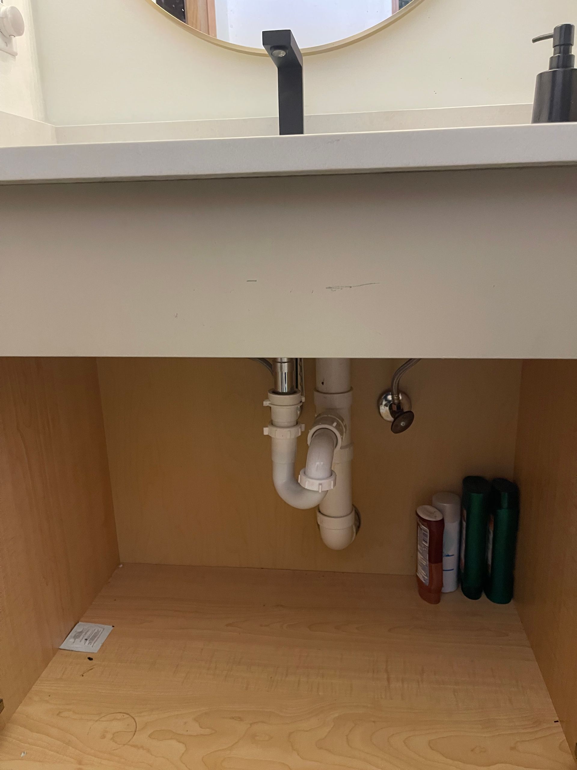 A bathroom sink with a plumbing pipe underneath it.