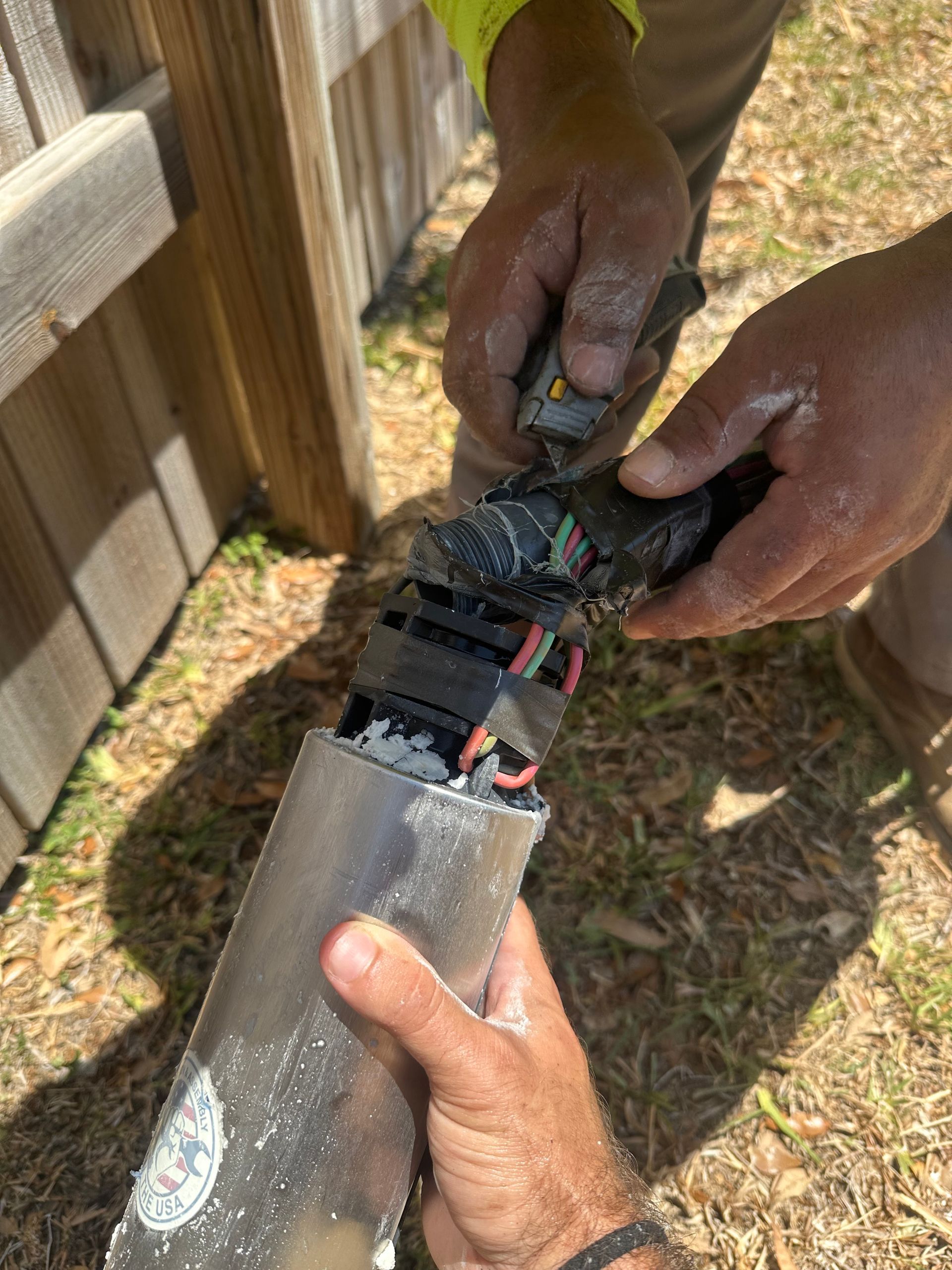 A person is holding a piece of metal in their hands.