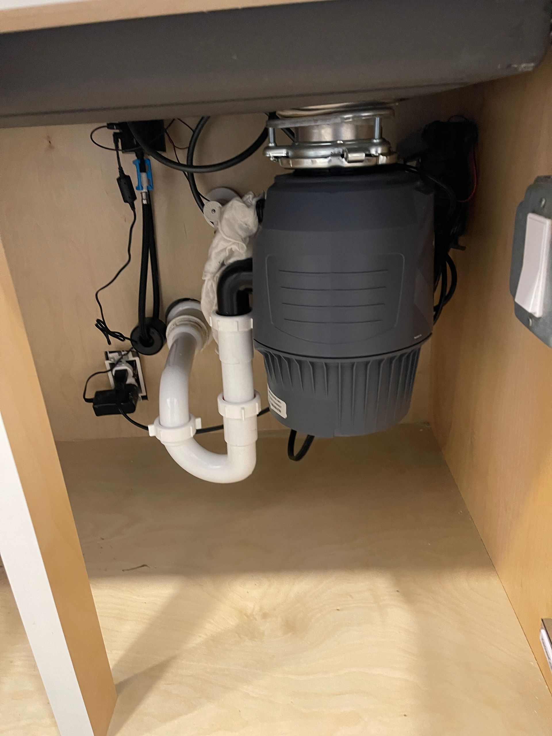 A sink with a garbage disposal underneath it.