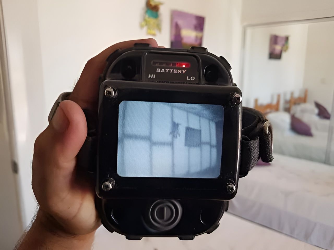 A Person is Holding a Camera That Says Battery on It — Superior Termite & Pest Control in Bundaberg, QLD