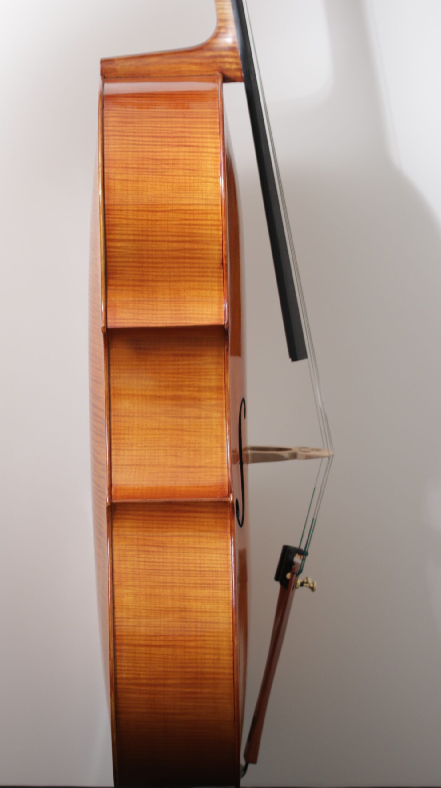 A close up of a cello with a bow on it