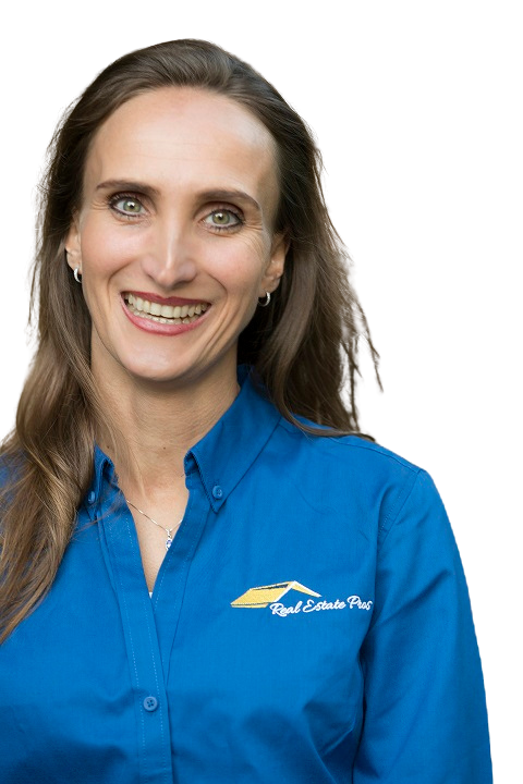 A woman in a blue shirt is smiling for the camera