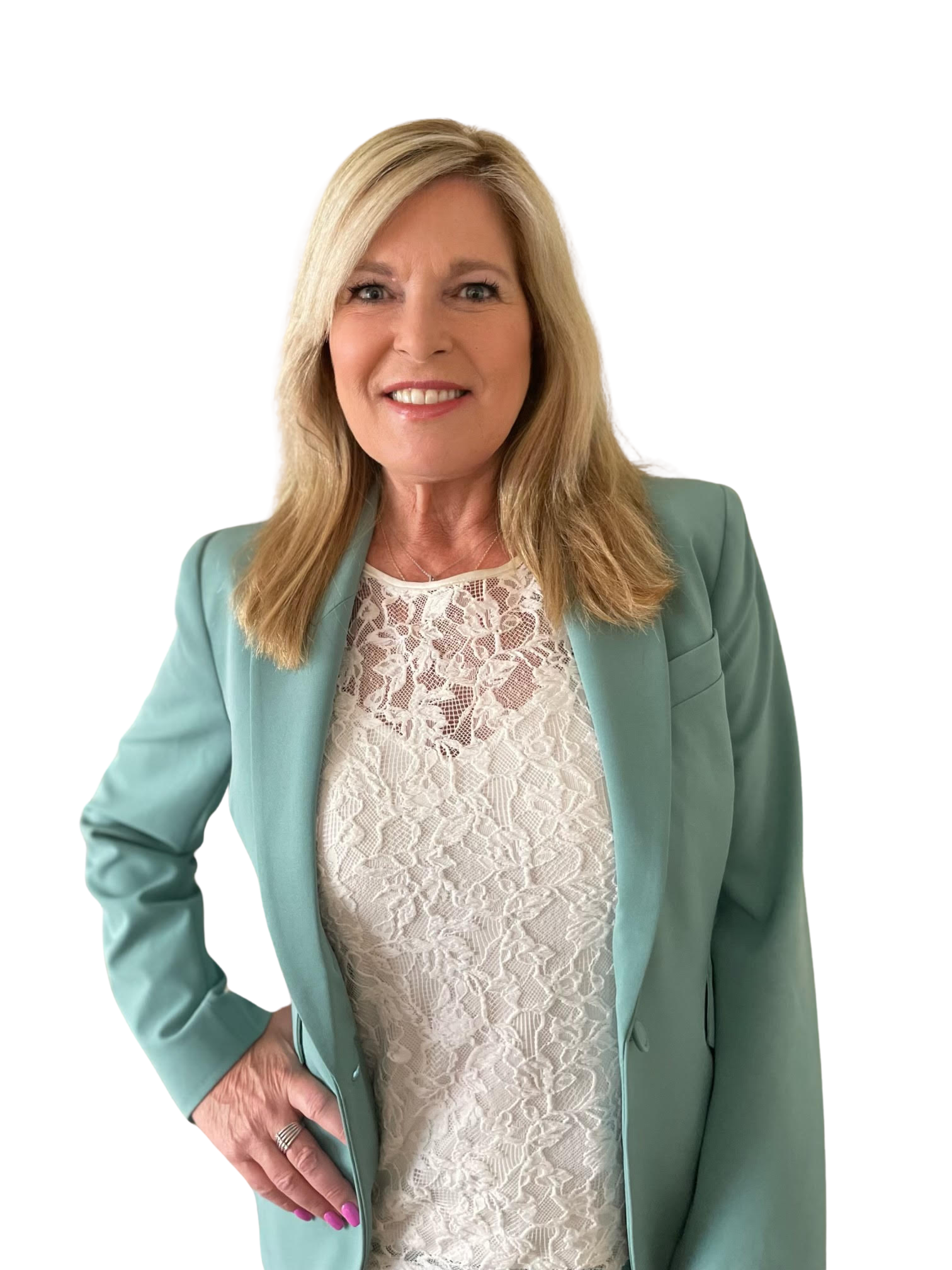A woman wearing a green jacket and a white lace top is standing with her hands on her hips.
