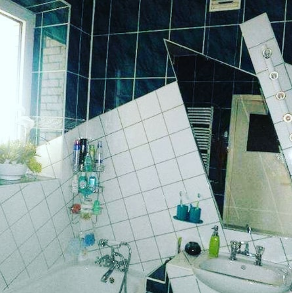 A bathroom with a bathtub sink and mirror