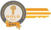 A gold key gkc logo with a key in the center.