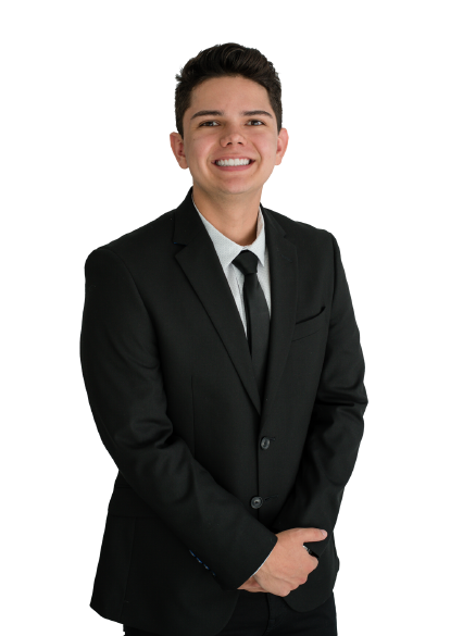 A young man in a suit and tie smiles for the camera