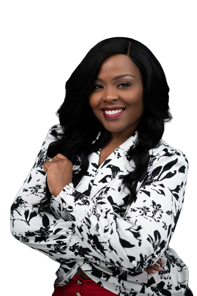 A woman in a black and white floral shirt is smiling with her arms crossed