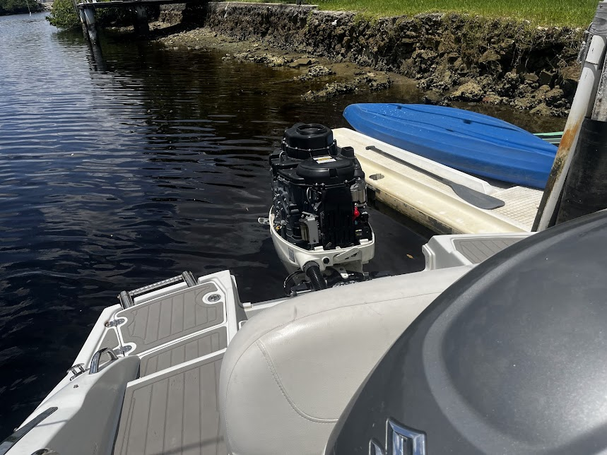 A suzuki outboard motor is sitting on the back of a boat