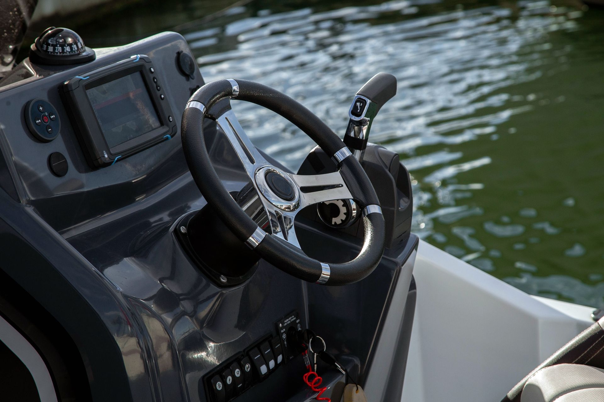 A boat with two outboard engines is parked in front of a building.