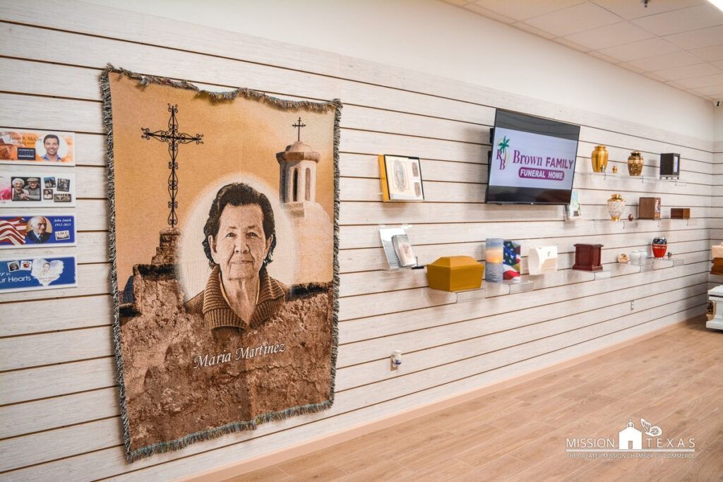 Gallery wall with a portrait artwork and small pieces displayed on white slatwall