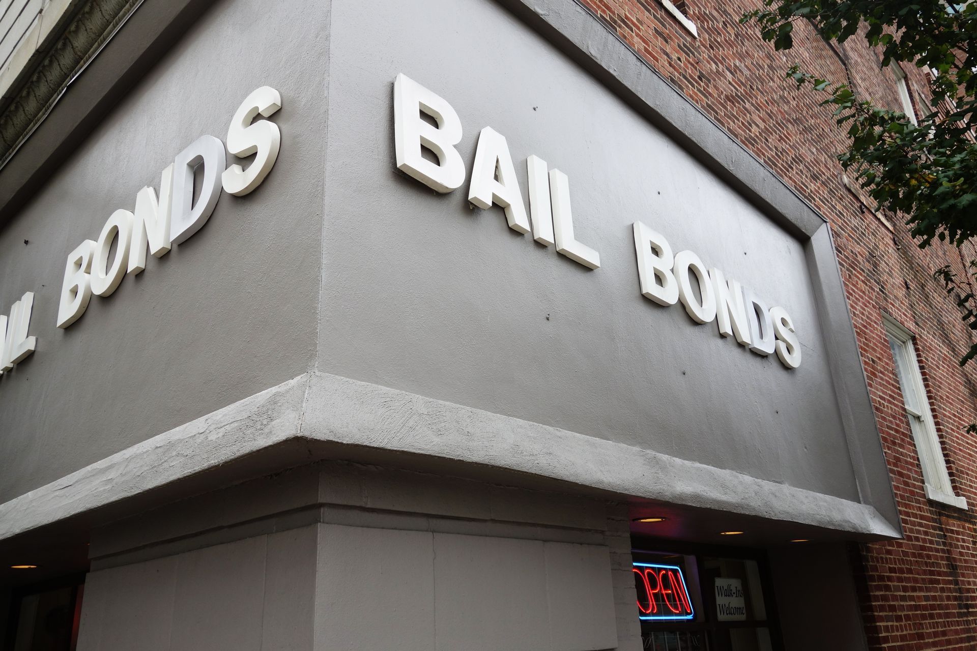Gray building corner with “Bail Bonds” sign and partial “Bonds” lettering on the wall