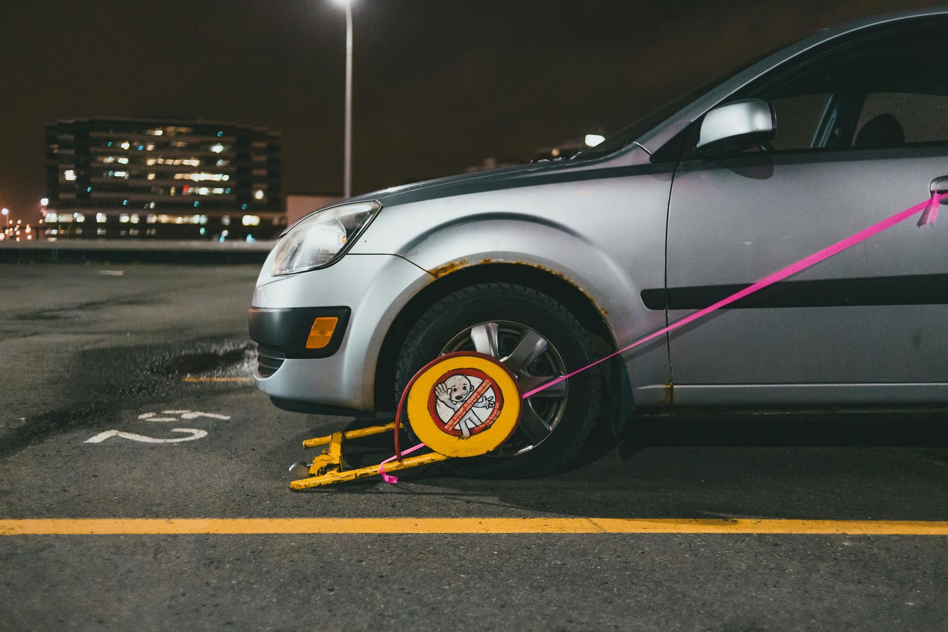 Grey car with a flat tire