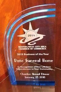 A clear glass award trophy with blue accents for Pate Funeral Home as the 2018 Business of the Year.