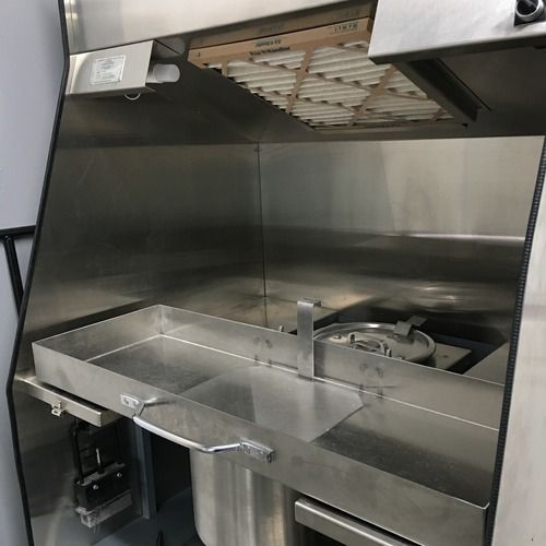 A stainless steel crematory refrigeration unit with an air filter at the top and an open bench.