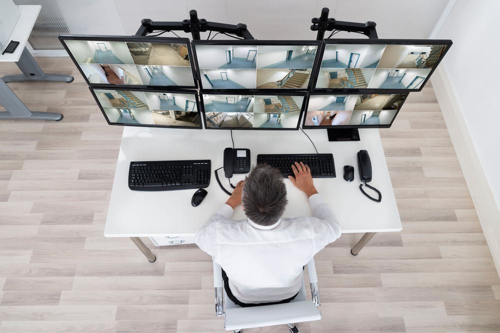 A Man Looking at A Bunch of Monitors — MNC Security in Sawtell, NSW