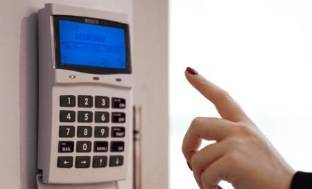 A Person Pressing a Button on A Security System — MNC Security in Woolgoolga, NSW