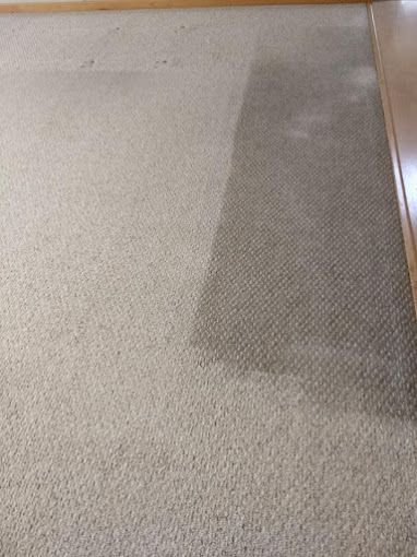 A close up of a carpet with a stain on it.