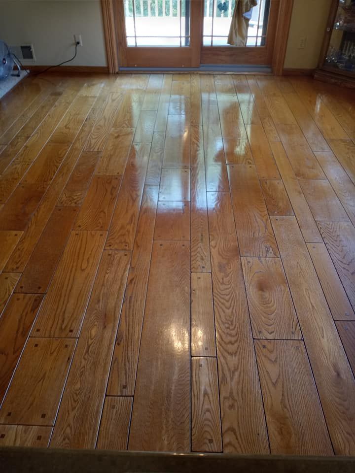 A living room with hardwood floors and sliding glass doors.