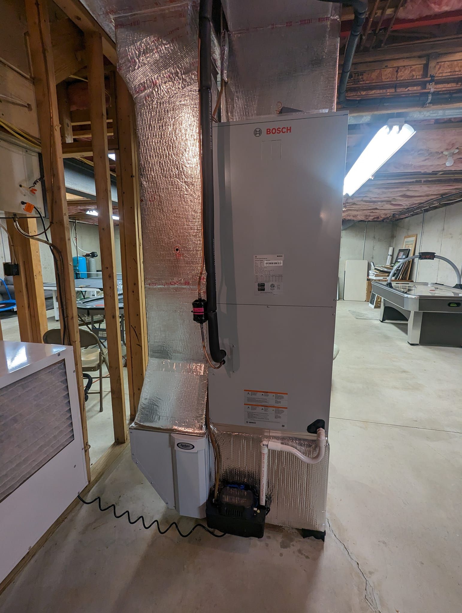 A large air conditioner is sitting in the middle of a room.
