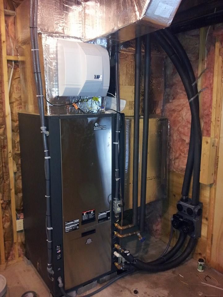 A heating and cooling system in a basement with pipes coming out of it