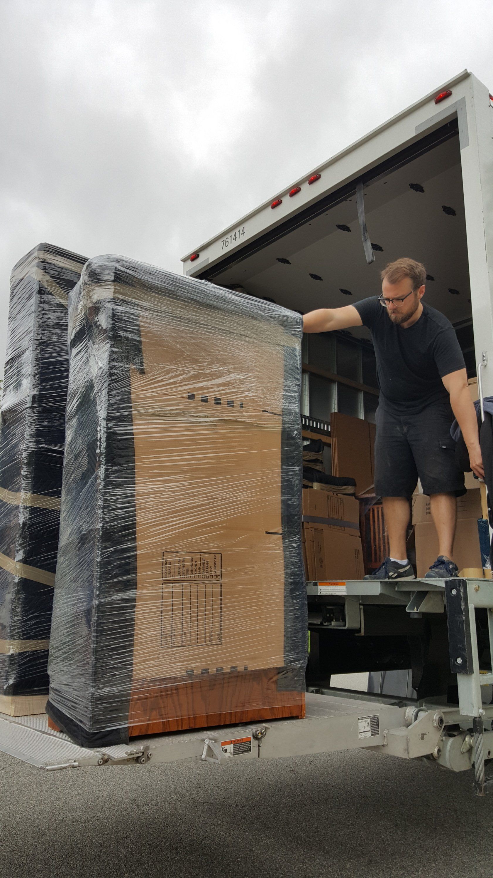 mover loading packed boxes into a truck