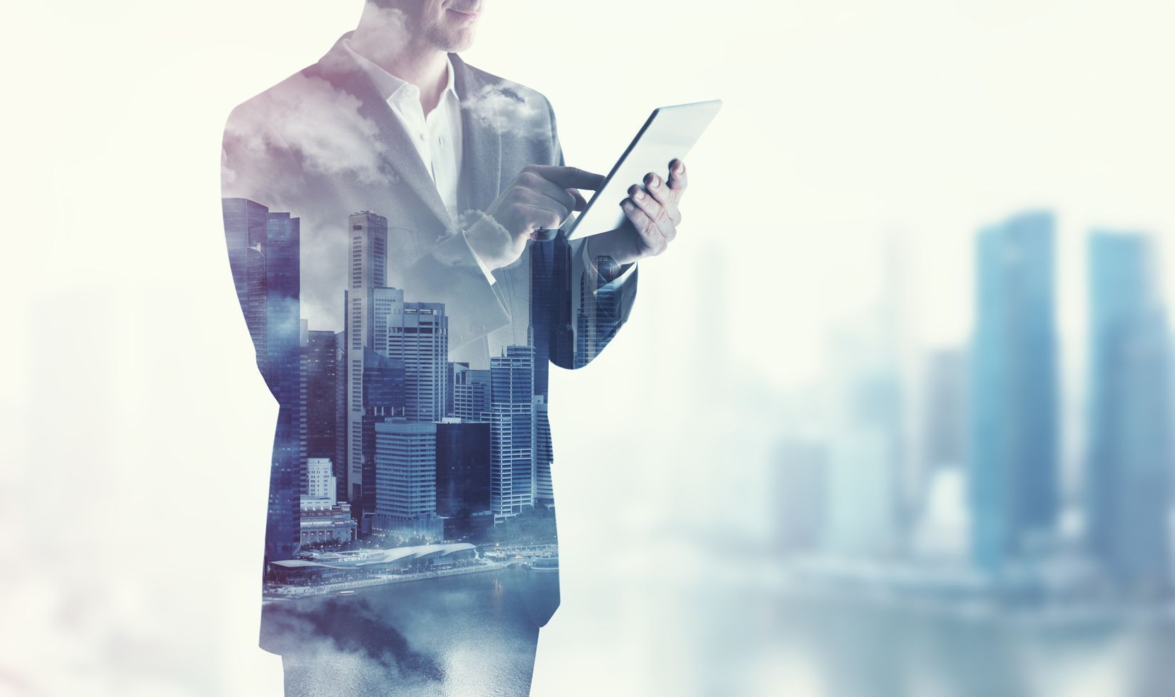 Businessman in suit holding tablet, overlaid with city skyline, blurred background.