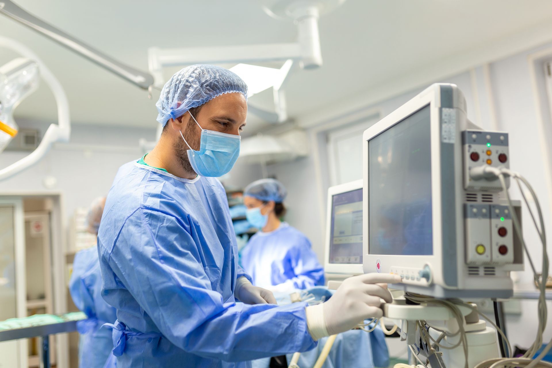 Medical team performing surgery under bright lights.