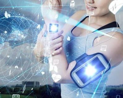 Woman exercising with smartphone in arm band, overlaid with digital data graphics.