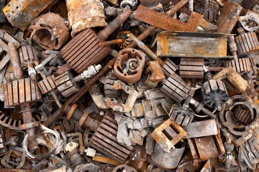 Rusty scrap metal and old machine parts piled together in a cluttered heap.