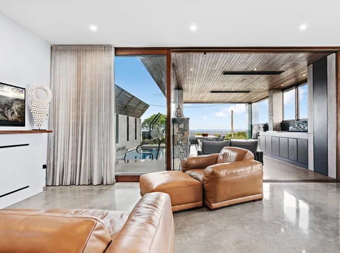Living Room With Tan Leather Chairs — Envisage Construction and Design in Woonona, NSW
