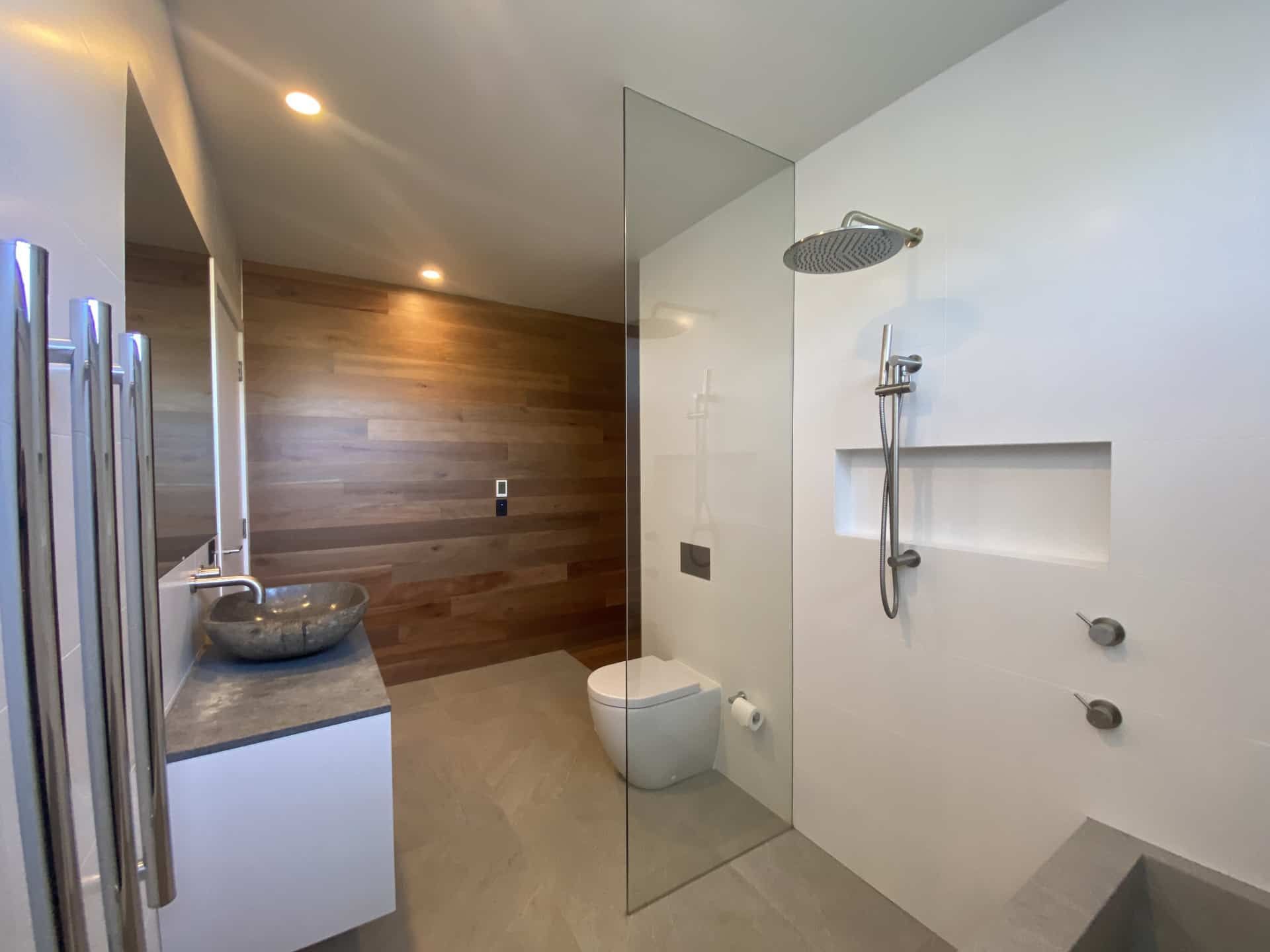Modern Bathroom With Wood Accent Wall — Envisage Construction and Design in Coledale, NS
