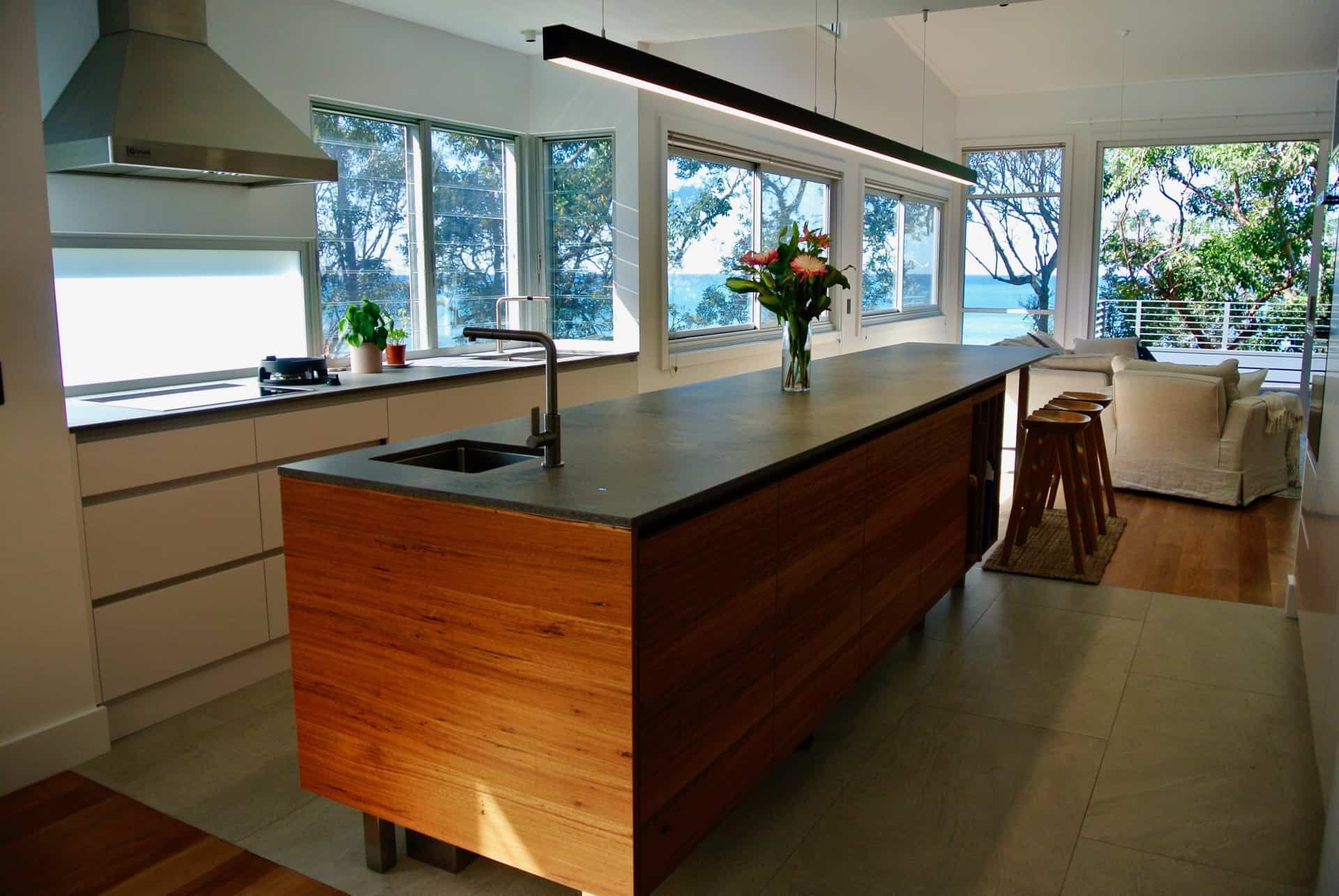 Modern Kitchen With Wood Island and Large Windows Overlooking Water — Envisage Construction and Design in Coledale, NS