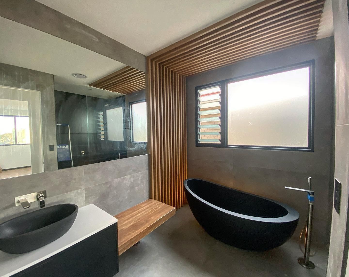 Modern Bathroom With Black Oval Tub — Envisage Construction and Design in Tasmania, NSW