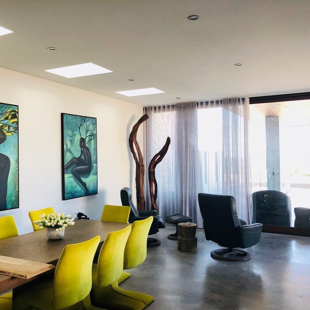 Modern Dining Room With a Long Wooden Table, Yellow Chairs, Artwork — Envisage Construction and Design in Mountain, NSW