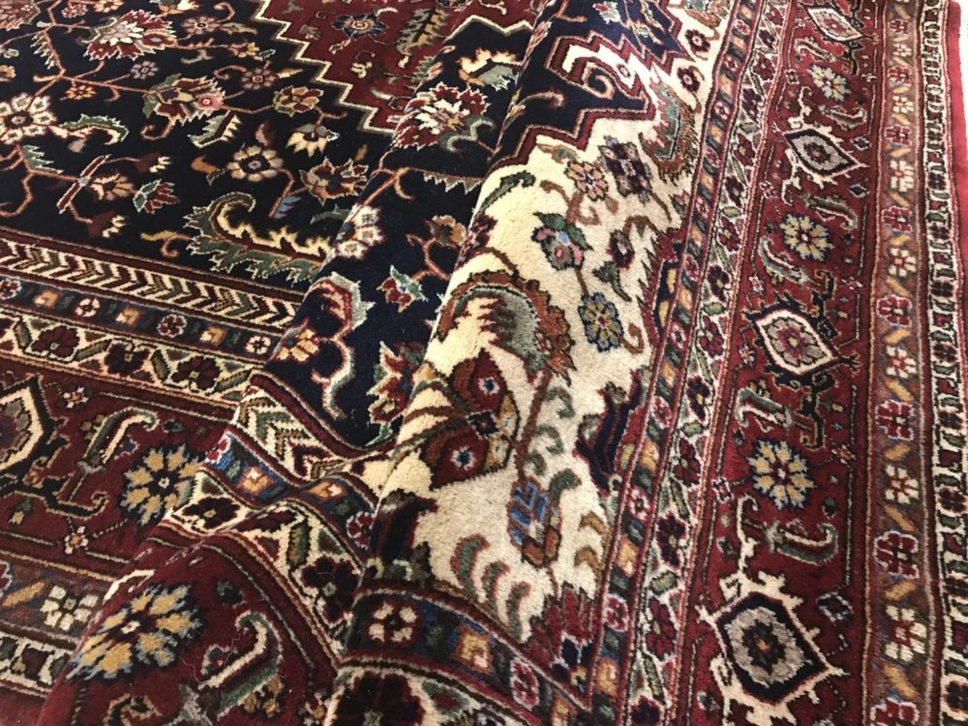 A close up of a rug with a floral pattern on it.
