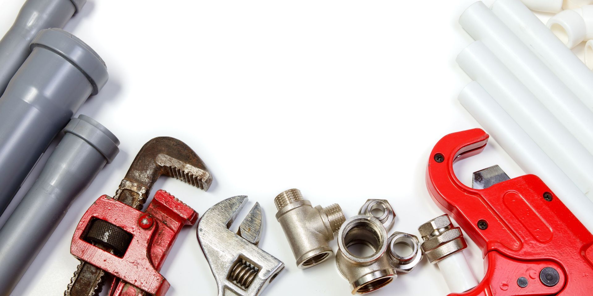 Plumbing tools, including wrenches, cutters, and pipes, against a white background.