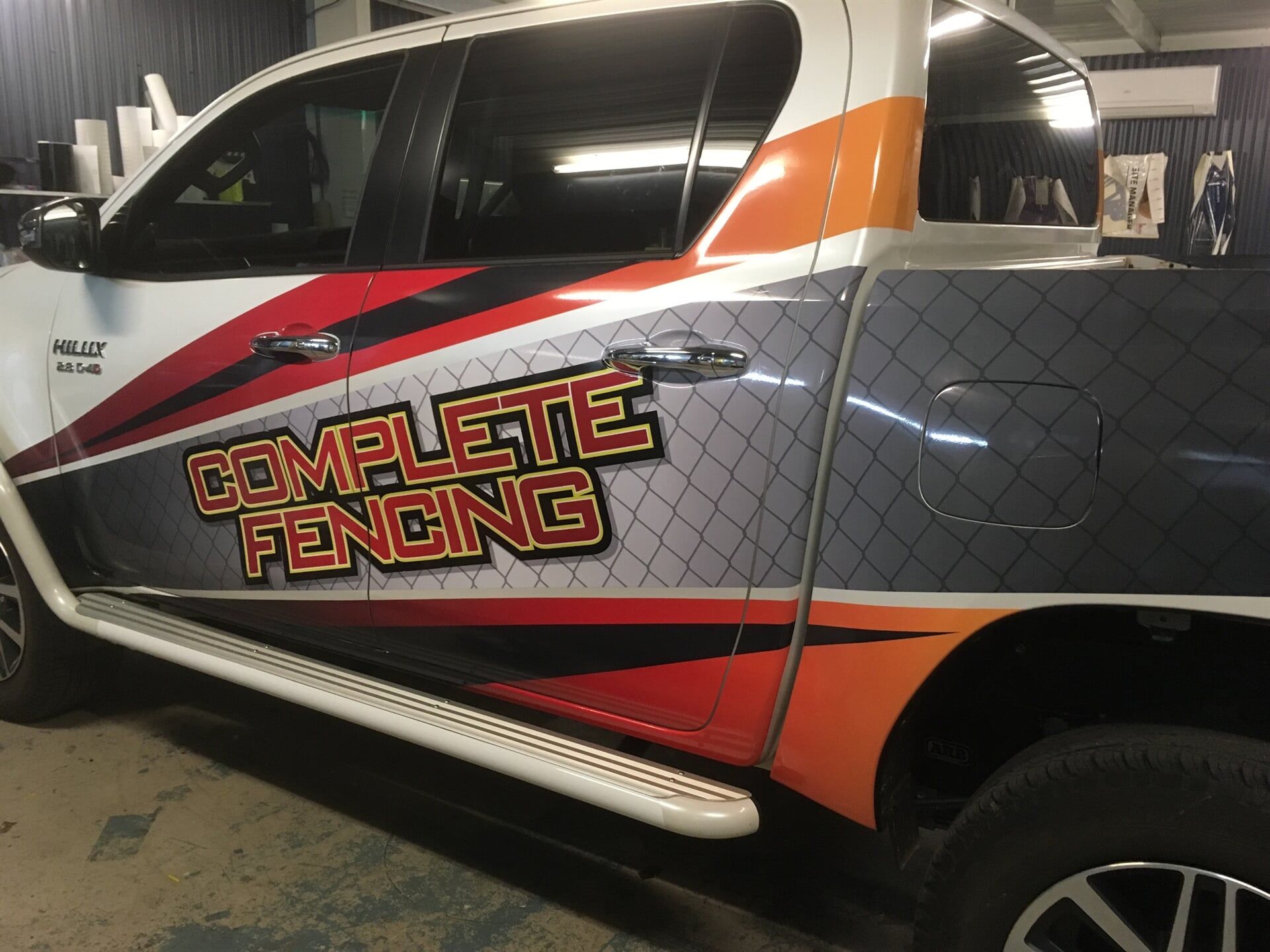 A truck with a fence wrap that says complete fencing — Bluey's Signs in Ciccone, NT