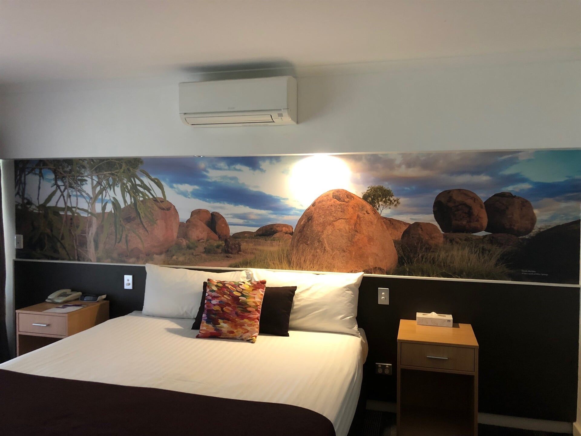 A Hotel Room With a Bed and a Picture of Rocks on the Wall — Bluey's Signs in Ciccone, NT