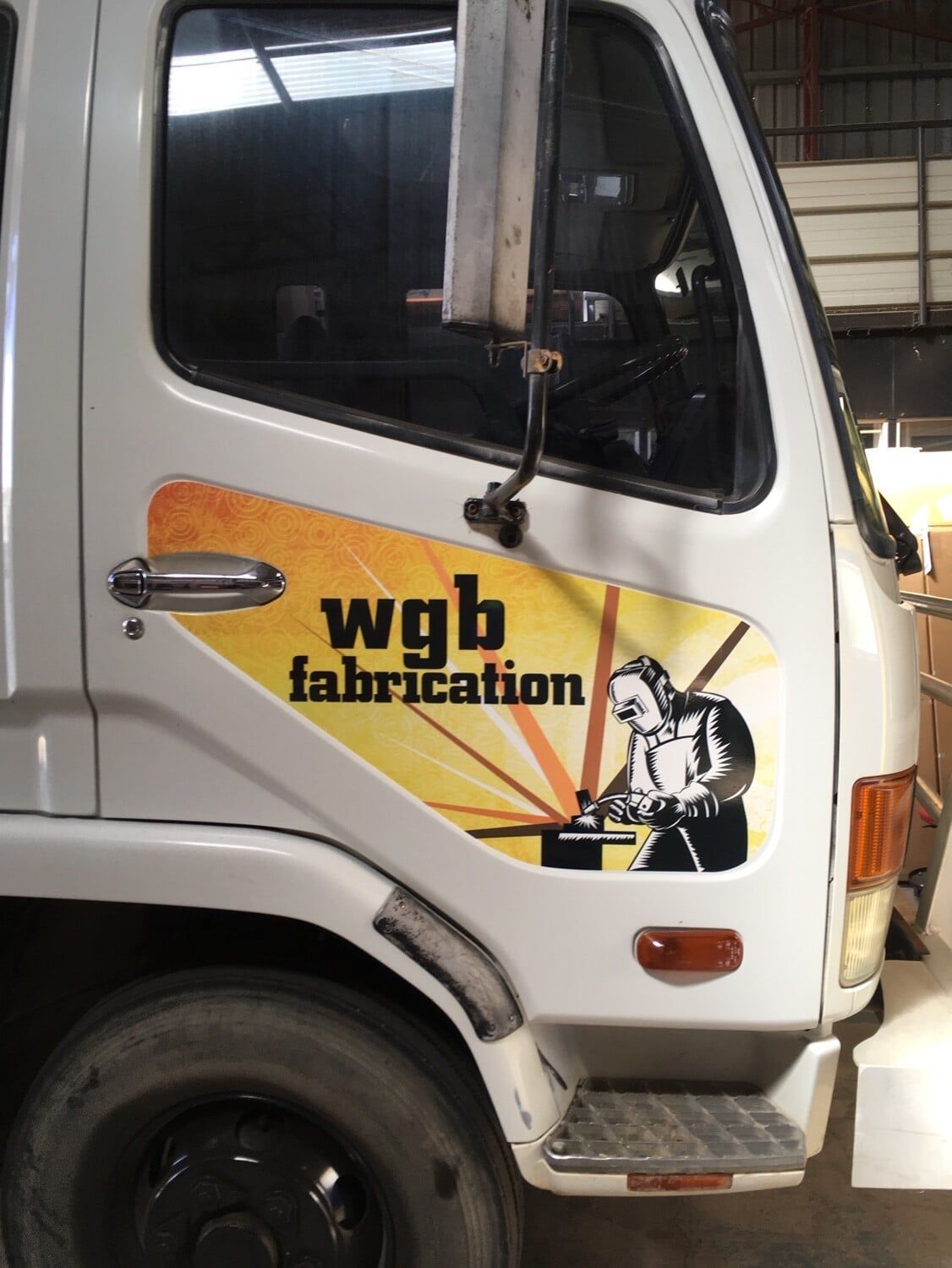 A White Truck Has a Sticker on the Side That Says Wgb Fabrication — Bluey's Signs in Ciccone, NT