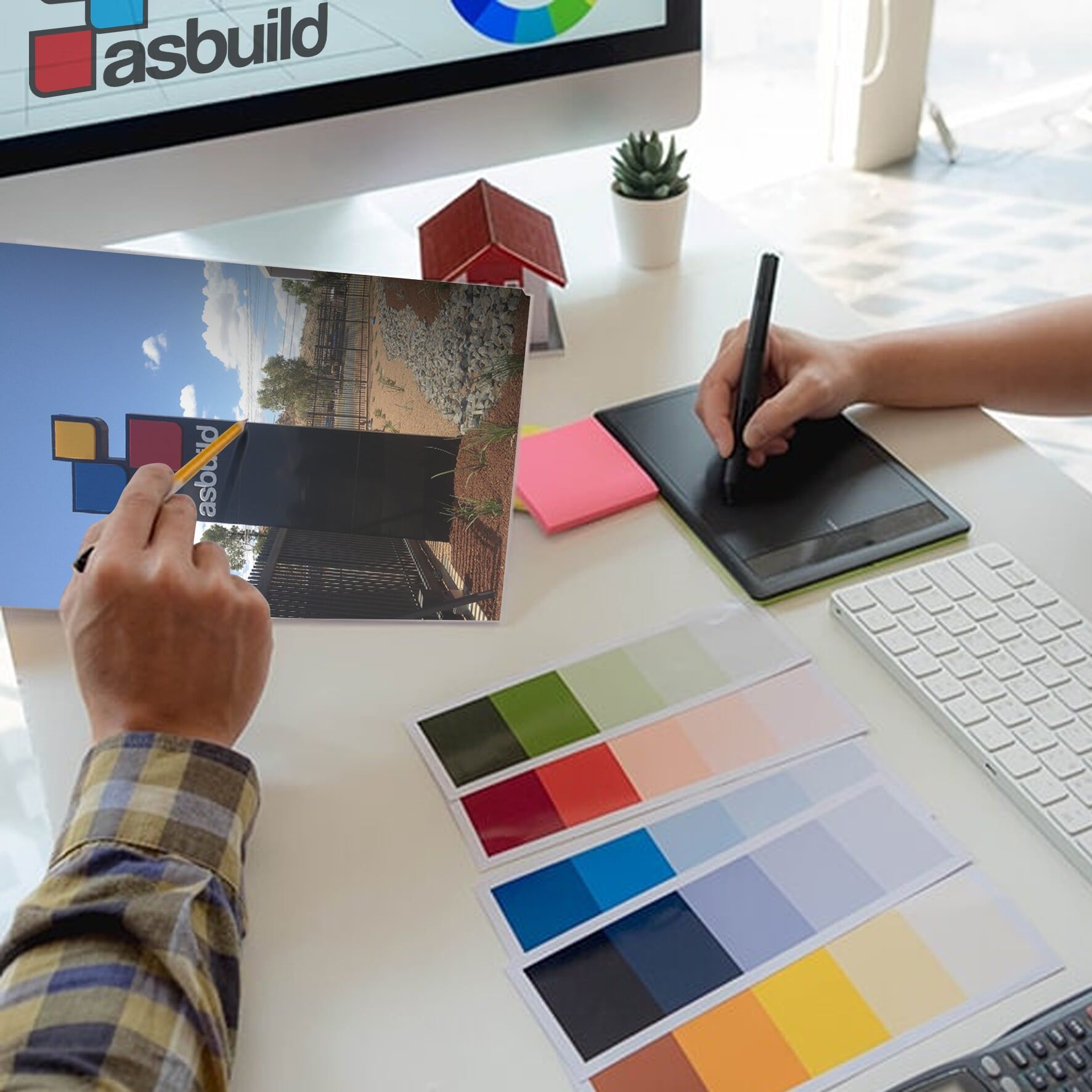 A Person is Using a Tablet in Front of a Computer Screen That Says Asbuild — Bluey's Signs in Ciccone NT