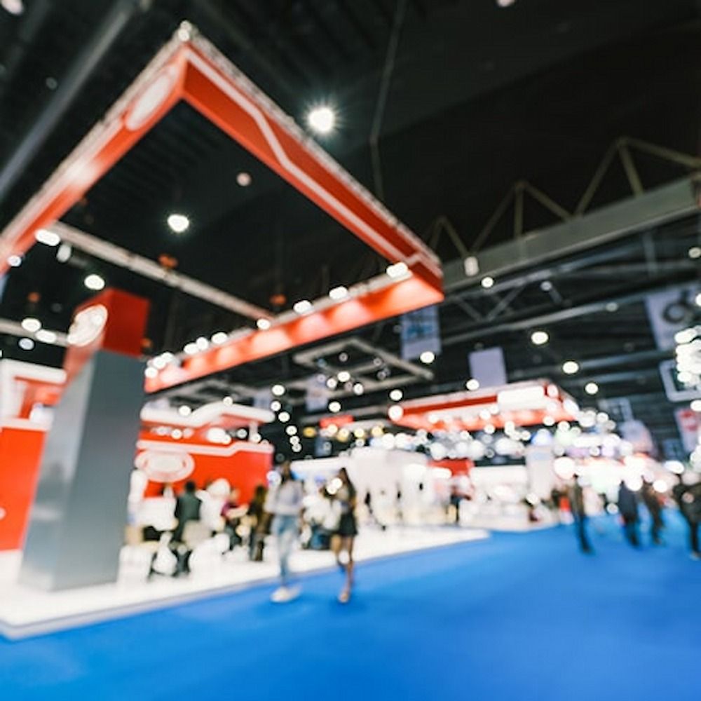 A Blurry Picture of People Walking in a Convention Center — Bluey's Signs in Ciccone, NT