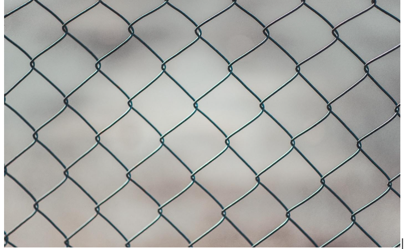 A close up of a chain link fence on a white background