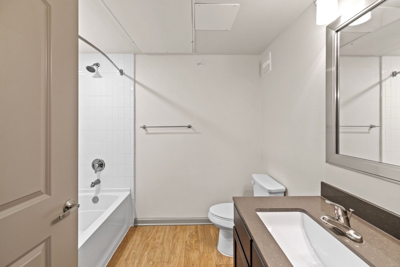 Bathroom with tub/shower, toilet, and vanity.