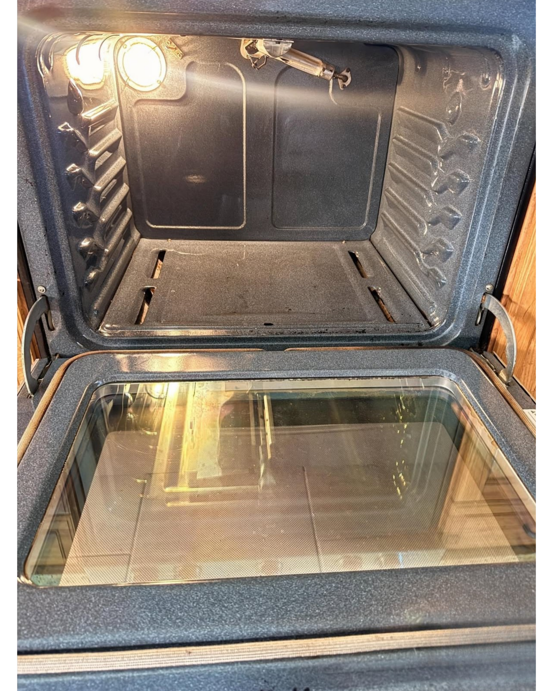 Moldy blue-taped sliding door track with dirty floor and patio outside