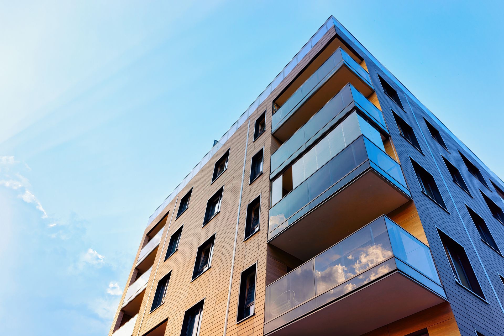 Modern apartment building with balconies against a blue sky Modern apartment building with balconies against a blue sky